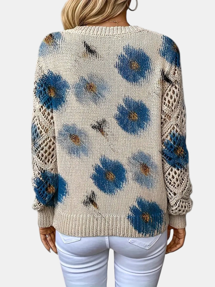 Red floral knit sweater seen from an elevated angle, capturing the overall silhouette.