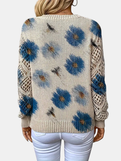 Red floral knit sweater seen from an elevated angle, capturing the overall silhouette.