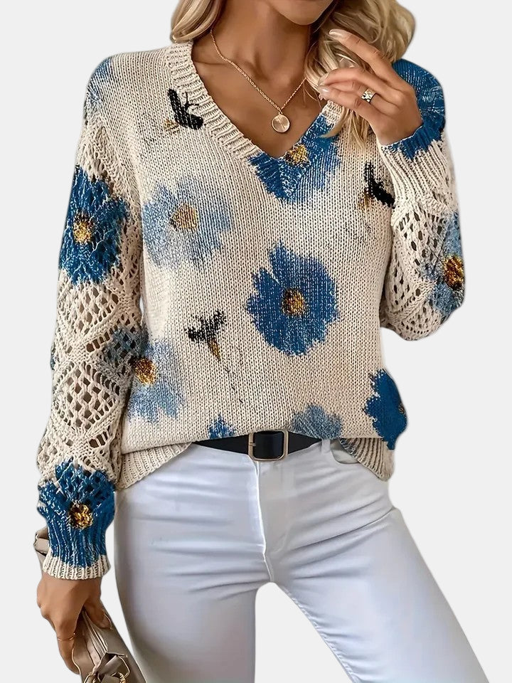 Close-up of the V-neckline on a green floral knit sweater, focusing on the stitch detail.