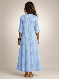 Side view of the white floral flowing maxi dress, highlighting its soft, breathable fabric texture.