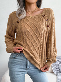 Model smiling while wearing the blue knitted sweater, illustrating its comfortable wear.