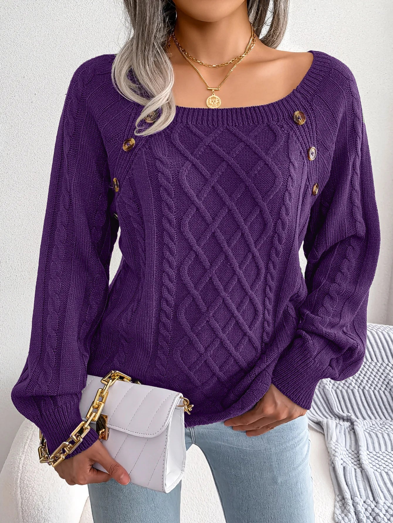 Three Lotte casual knitted sweaters in different colours (red, orange, grey) stacked together.