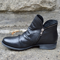 Side profile of a black Hadley ankle boot, highlighting the practical side zip closure and low block heel.