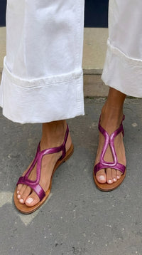 A close-up of the foot in a fuchsia relaxed everyday sandal, focusing on the relaxed fit.