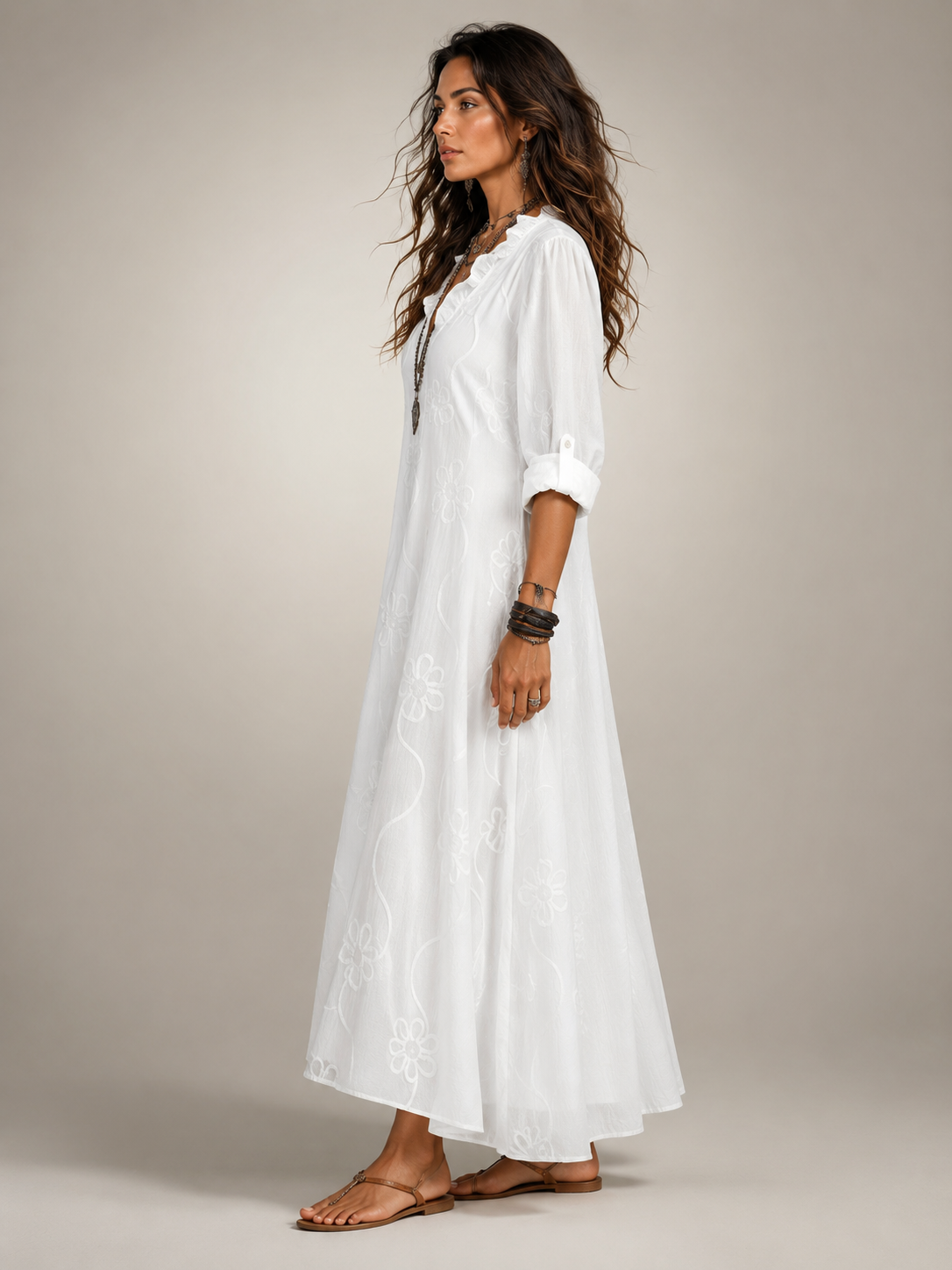 Close-up of the ruffled V-neckline and sleeve detail on the black Lotte flowing maxi dress.