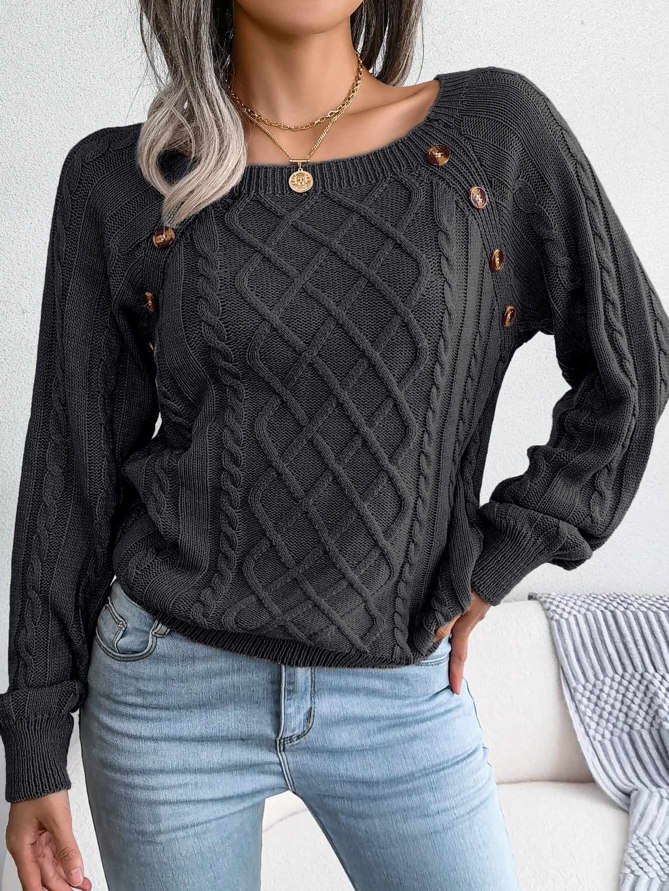 Close-up of the soft fabric texture of the grey Lotte casual knitted sweater.