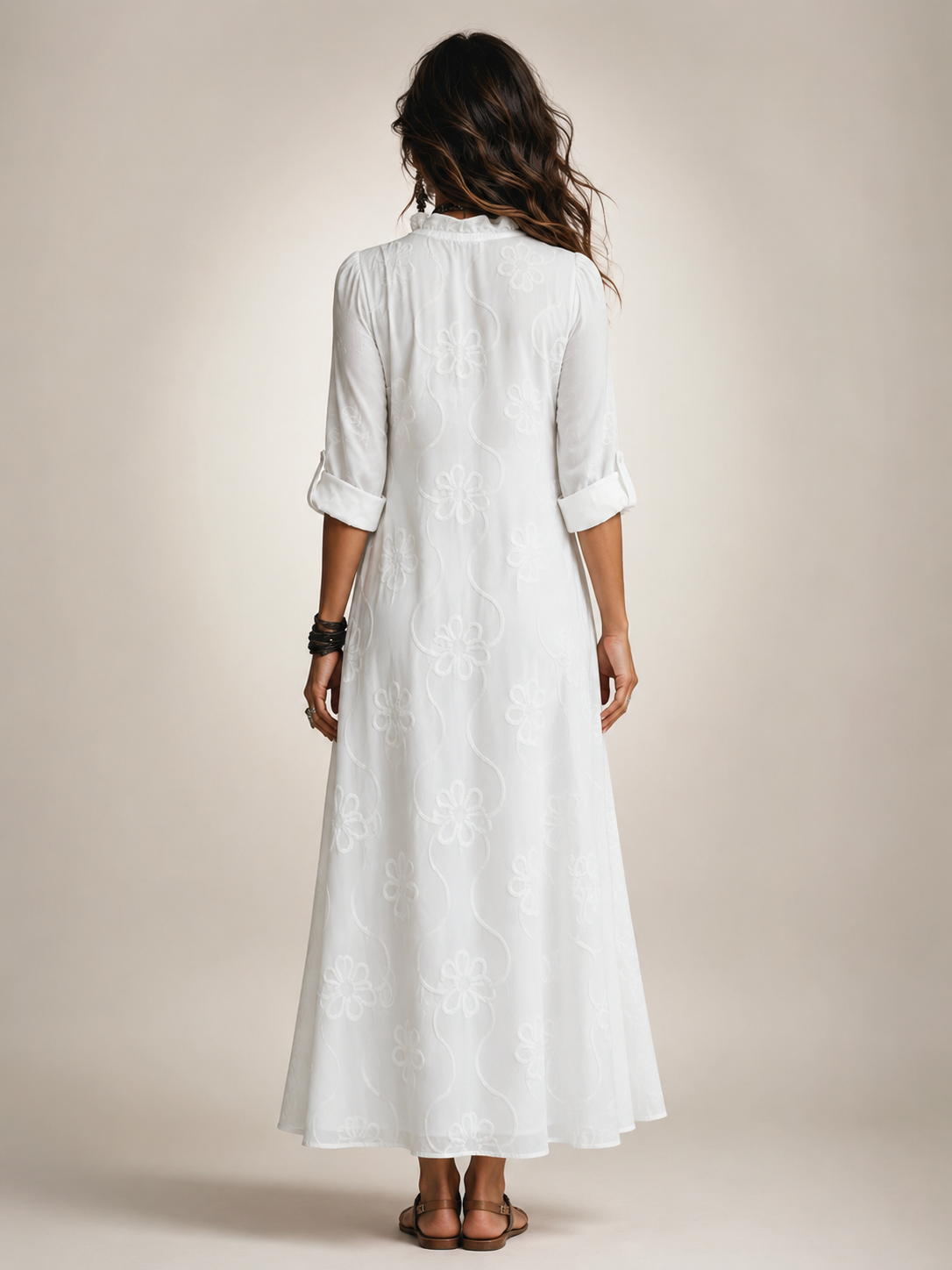 A woman in the black Lotte floral flowing maxi dress, walking casually outdoors.