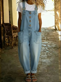 Back view of a woman walking in the black casual denim jumpsuit, showing the full length and how it drapes.