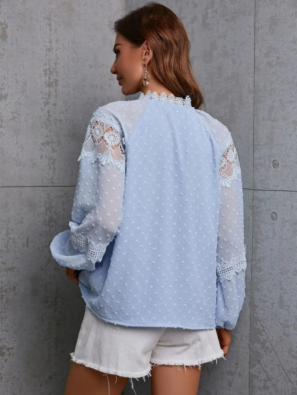 Full length view of the misty blue crochet blouse, illustrating its versatile styling potential for various occasions.