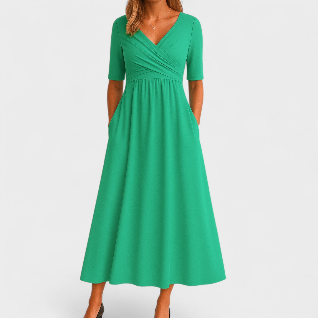 Back view of the Lynton elegant midi dress in blue, illustrating the midi length and overall drape of the garment.