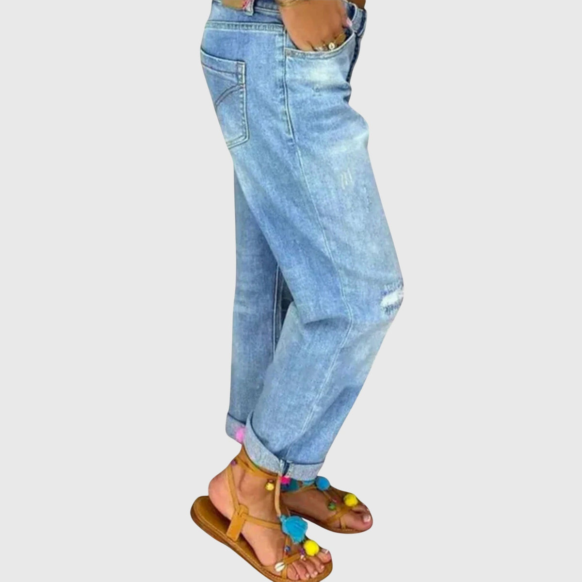 Close-up of the premium denim fabric and stitching details on the thigh of the blue relaxed straight jeans.