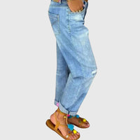 Close-up of the premium denim fabric and stitching details on the thigh of the blue relaxed straight jeans.