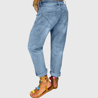 Rear view of the Zara relaxed straight jeans, highlighting the back pockets and overall silhouette on a model walking outdoors.