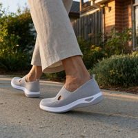Detail shot of the thick cushioned sole of a blue Margot slip-on sneaker, emphasizing its shock-absorbing quality.