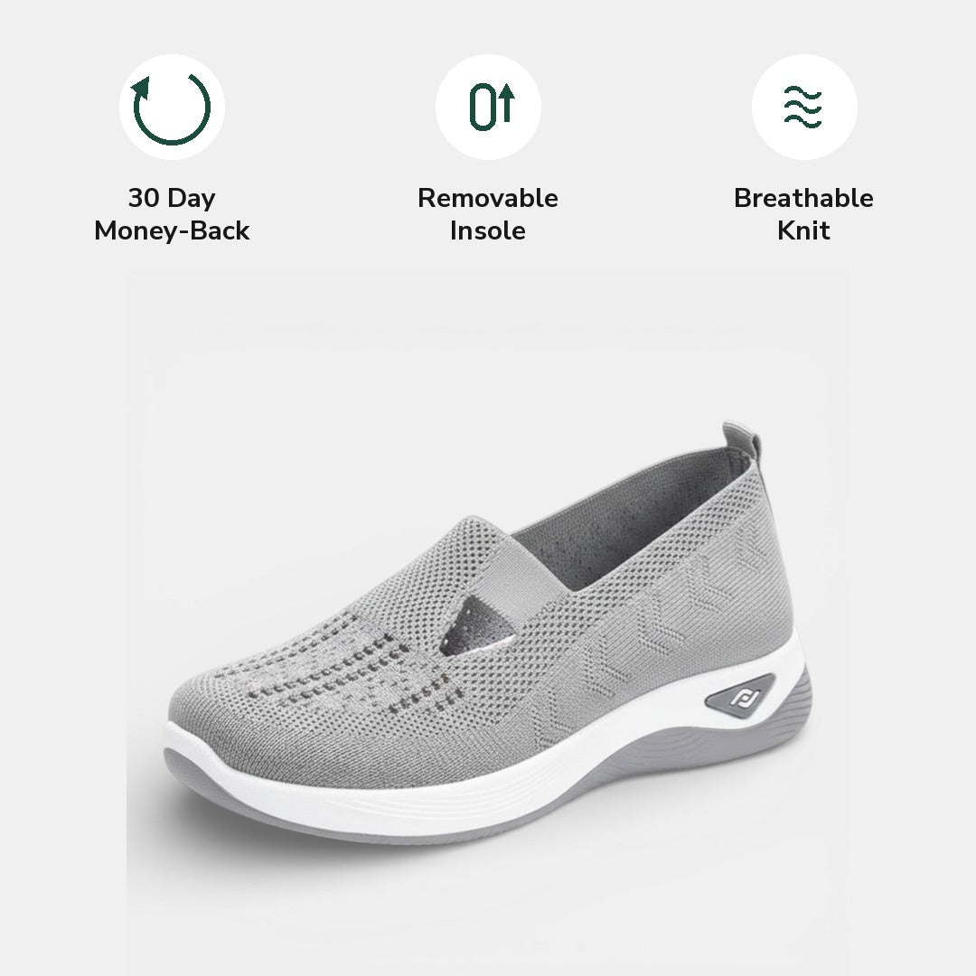 The removable cushioned insole being lifted out of a red Margot comfort sneaker, showing its customisable feature.