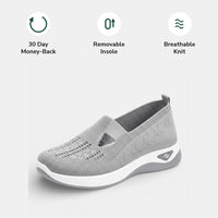 The removable cushioned insole being lifted out of a red Margot comfort sneaker, showing its customisable feature.