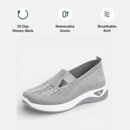 The removable cushioned insole being lifted out of a red Margot comfort sneaker, showing its customisable feature.