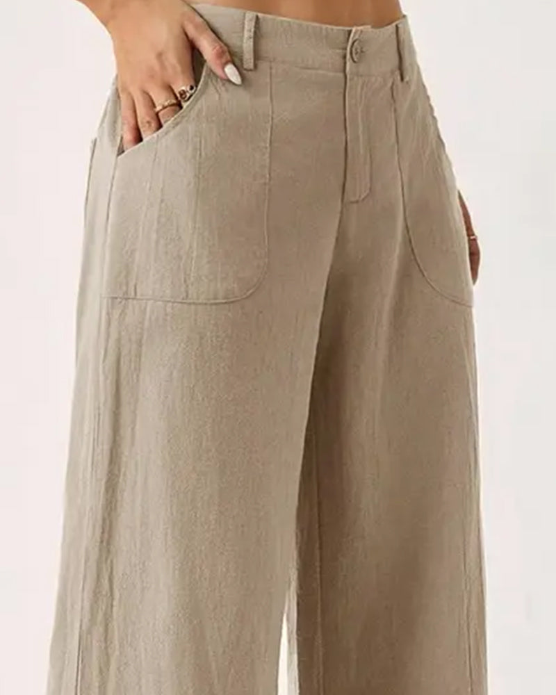 Close-up of the elasticated waistband and pocket detail on the coffee-coloured casual trousers.