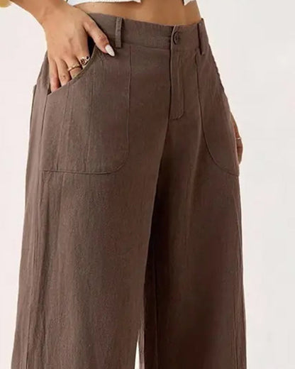 Lifestyle shot of a woman wearing the khaki Marlène trousers, walking casually outdoors.