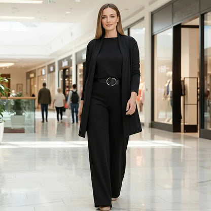 Back view of the black Marlowe elegant 3-piece set worn by a model, emphasising the drape of the cardigan and trousers.