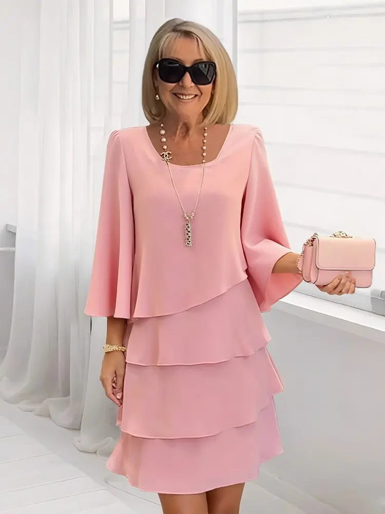 Front view of the Antonia elegant ruffle dress in pink, showcasing its flowing A-line silhouette and delicate ruffles.