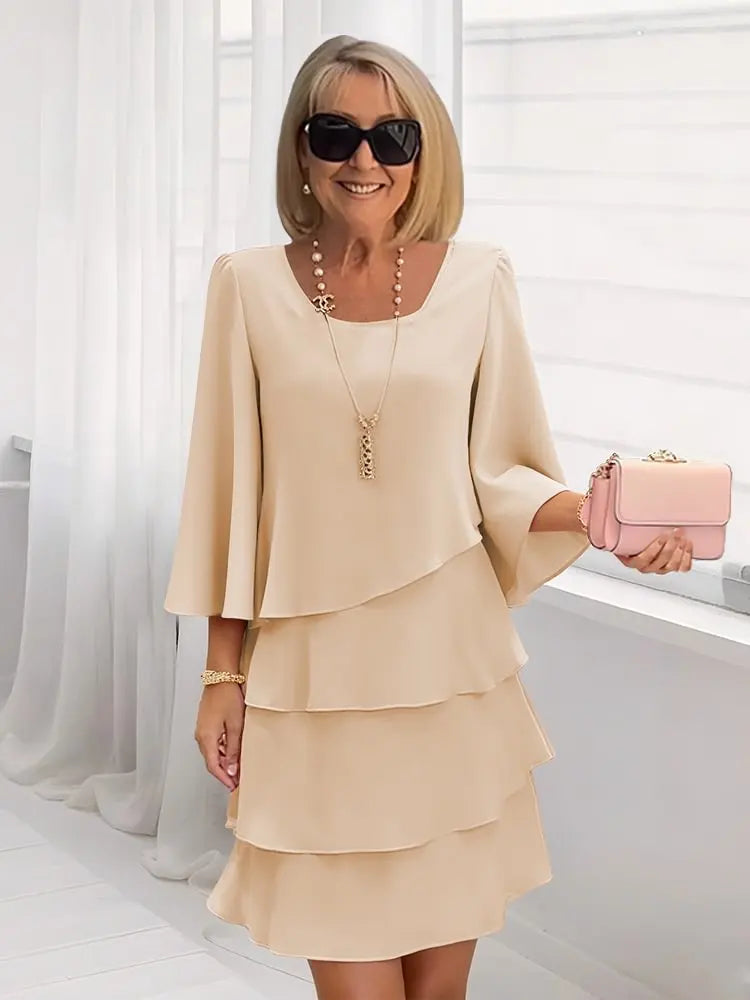 Back view of the elegant ruffle A-line dress in khaki, demonstrating its flattering drape and classic round neckline.
