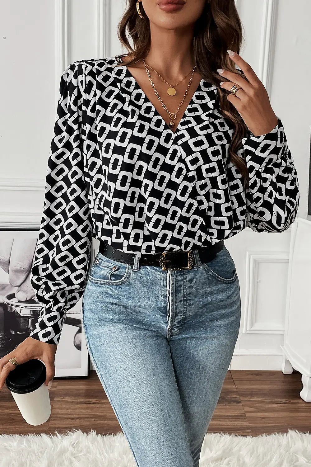 Close-up detail of the V-neckline and intricate pattern on the Nadia long sleeve blouse, highlighting fabric texture.