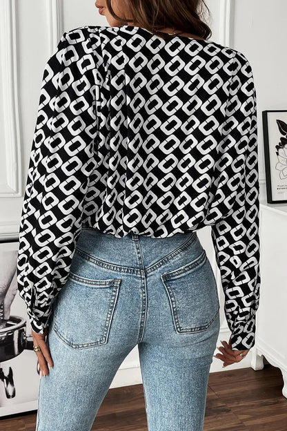 Lifestyle shot of the Nadia patterned blouse styled with smart trousers, ideal for a professional work environment.