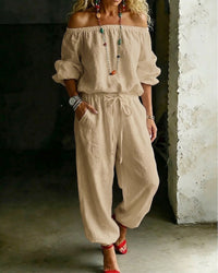A flat lay image of the Rhiannon off-shoulder cotton jumpsuit, neatly folded to show its design details.