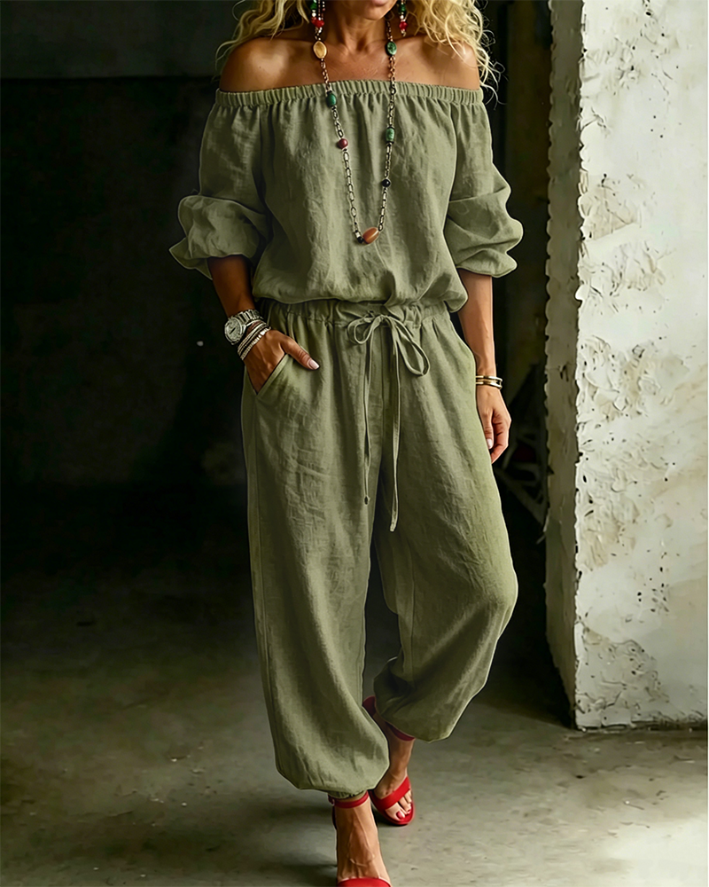 Side view of the Rhiannon off-shoulder cotton jumpsuit in a vibrant pink, adding a pop of colour to summer fashion.