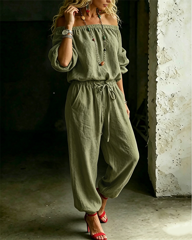 Back angled view of the Rhiannon off-shoulder cotton jumpsuit, showing the relaxed fit from behind.