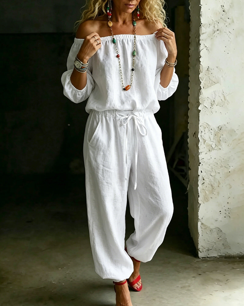 Close-up detail of the off-shoulder neckline and gathered fabric on the Rhiannon casual jumpsuit in a soft blue colour.