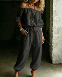 Model walking in the Rhiannon off-shoulder cotton jumpsuit, illustrating its movement and flow for a relaxed summer look.
