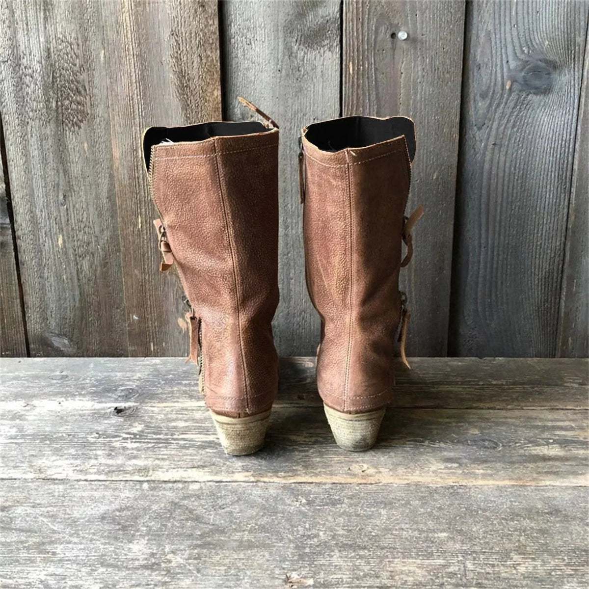 Overhead shot of the interior of a brown cowgirl boot, revealing the soft, warm lining designed for comfort in colder weather.