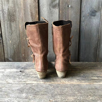 Overhead shot of the interior of a brown cowgirl boot, revealing the soft, warm lining designed for comfort in colder weather.
