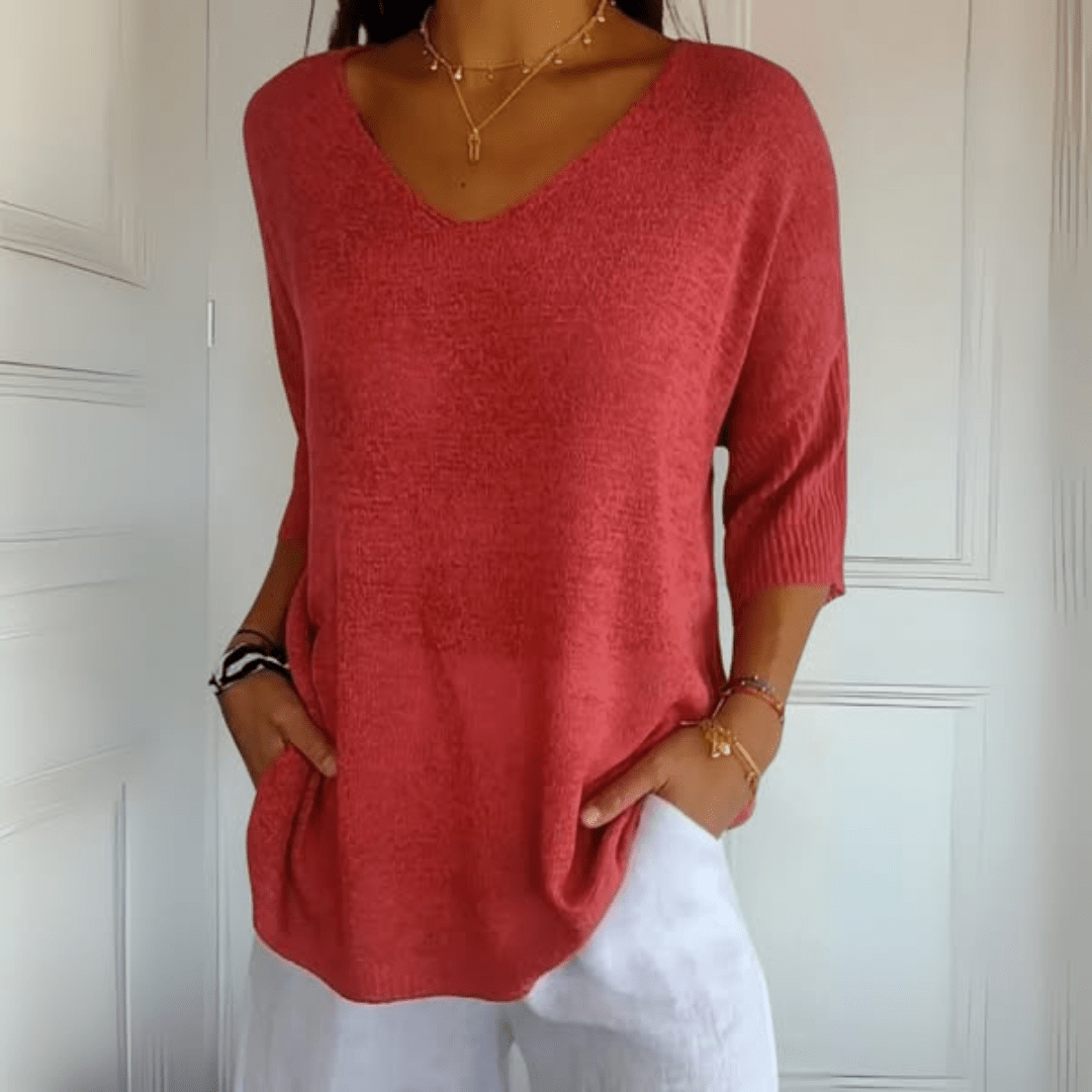 Front view of a woman wearing the Ophelia V-Neck loose sweater in a light colour, showcasing its relaxed fit.