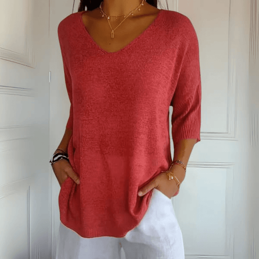Front view of a woman wearing the Ophelia V-Neck loose sweater in a light colour, showcasing its relaxed fit.