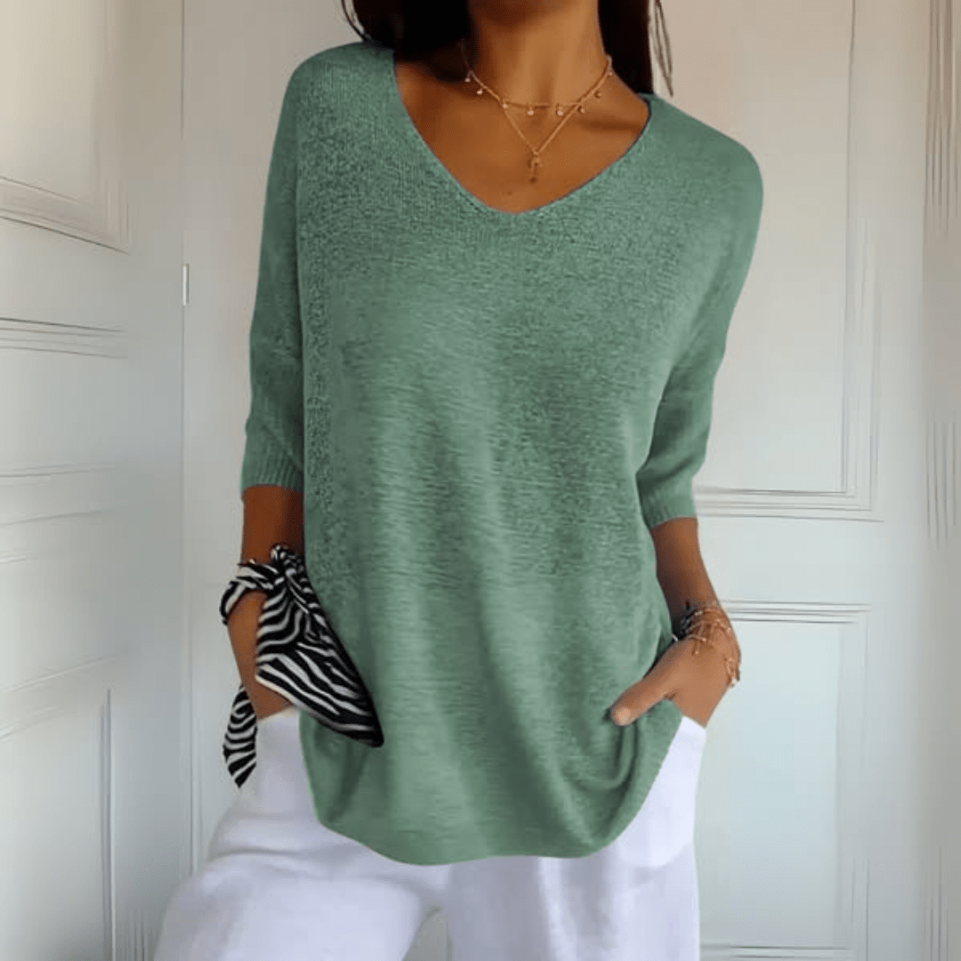 Side profile of a woman in the Ophelia V-Neck loose sweater, highlighting the three-quarter sleeve length.