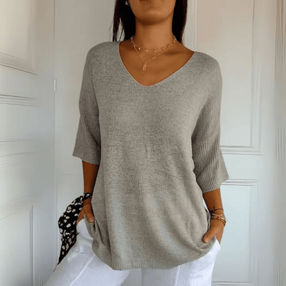 Rear view of the Ophelia loose sweater, demonstrating the smooth, clean finish of the hemline.