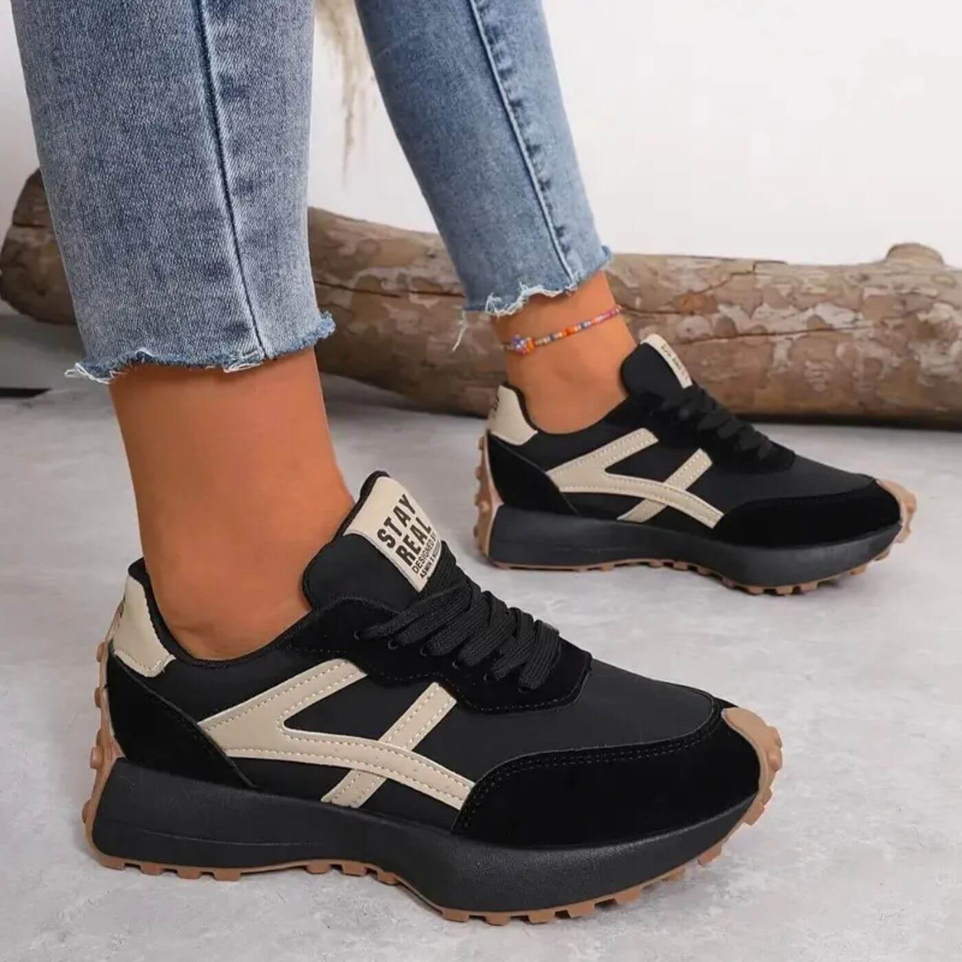 Front view of the cream orthopaedic panel sneakers, showcasing the lace-up design and textured sole.