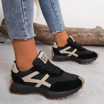 Front view of the cream orthopaedic panel sneakers, showcasing the lace-up design and textured sole.