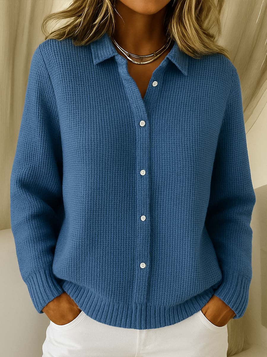 Close-up detail of the button-front closure and classic collar on a navy blue Peridot women's collared jumper.