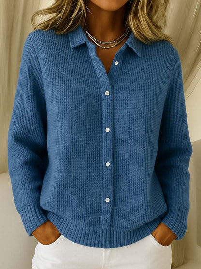 Close-up detail of the button-front closure and classic collar on a navy blue Peridot women's collared jumper.