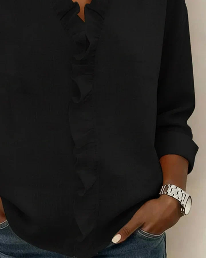 Close-up of the clear cuff on the long sleeve of the Persephone blouse, illustrating the refined finish.