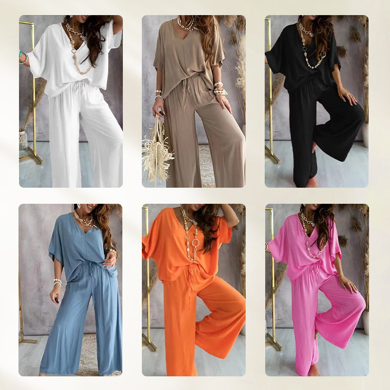 Back view of a woman walking away, highlighting the flow and drape of the black comfortable loungewear set.