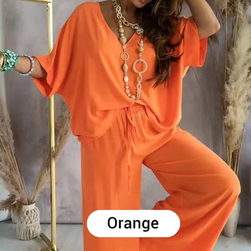 Detail of the elasticated waistband and trouser leg of the orange comfortable loungewear set.
