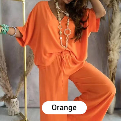 Detail of the elasticated waistband and trouser leg of the orange comfortable loungewear set.