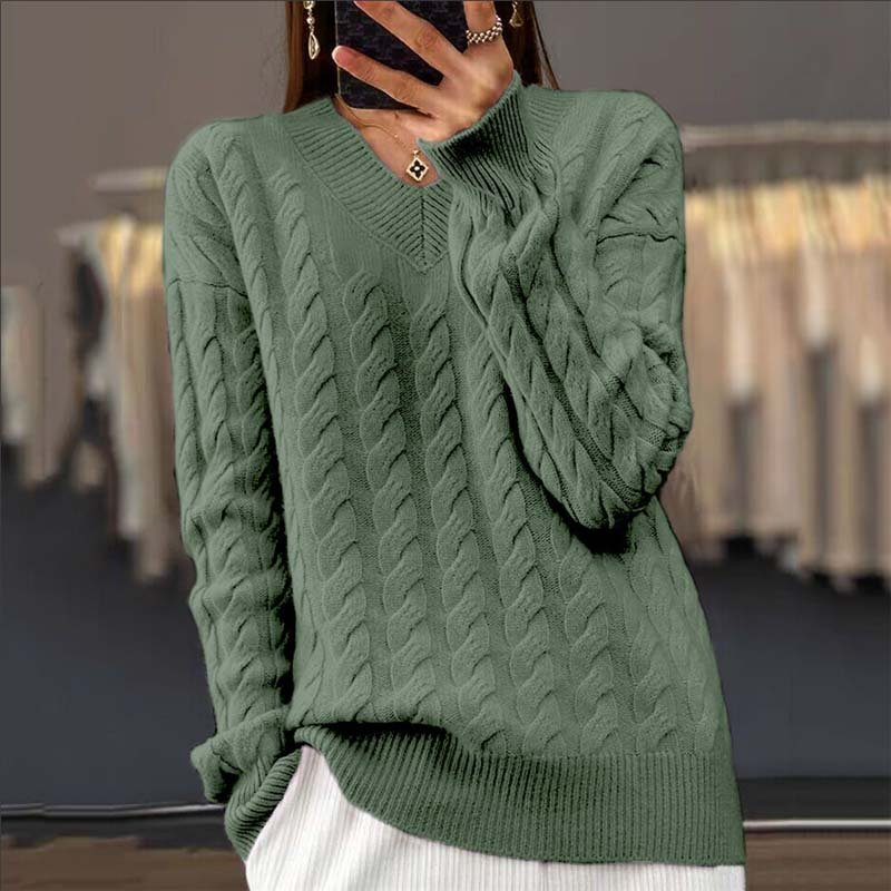A woman wearing the relaxed-fit Rosalie Classic Cable Knit Sweater, styled casually for a daytime outing.