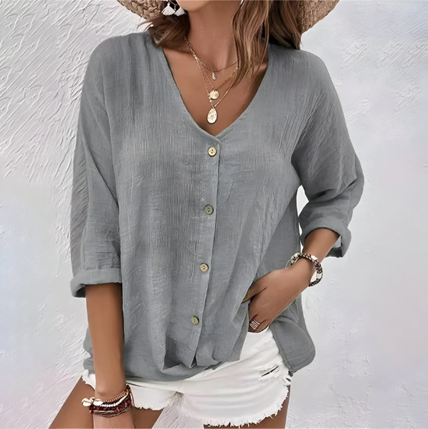 Side profile of the women's relaxed fit blouse, highlighting the elbow-length sleeves and comfortable drape.