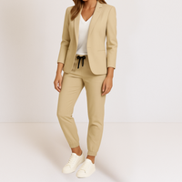 A model showcasing the Saskia tailored jacket in an evening wear context, highlighting its adaptability.
